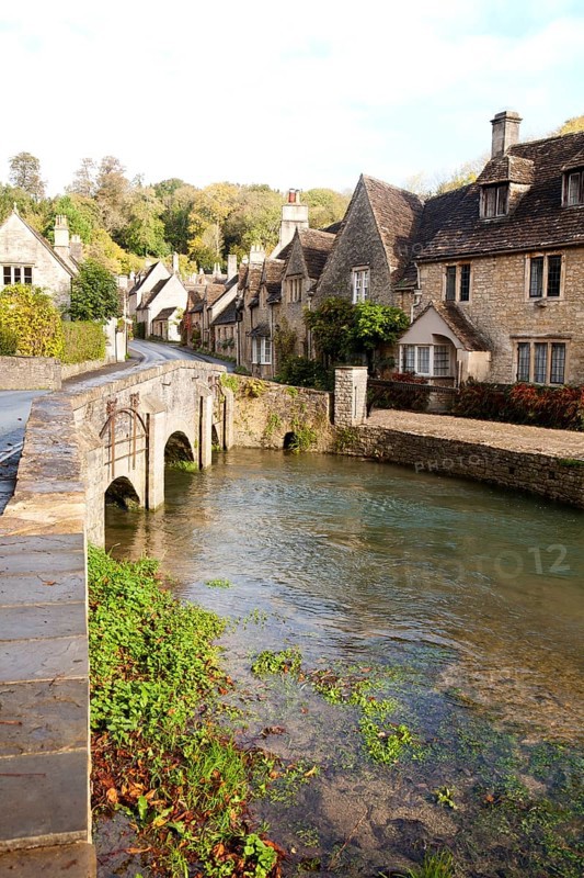 Bybrook River running past stone cottages in Castle Combe, Wiltshire, England, UK claimed to be England's prettiest village