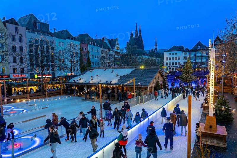 Ice rink at the Christmas market on the Heumarkt in the old town of Cologne, Cologne Cathedral, Sunday shopping in Cologne city centre, 1st Advent weekend, North Rhine-Westphalia, Germany, Europe