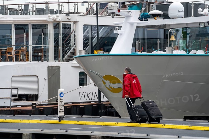 River cruise ships at the quay of the Ij, near the main railway station, passengers' luggage being loaded