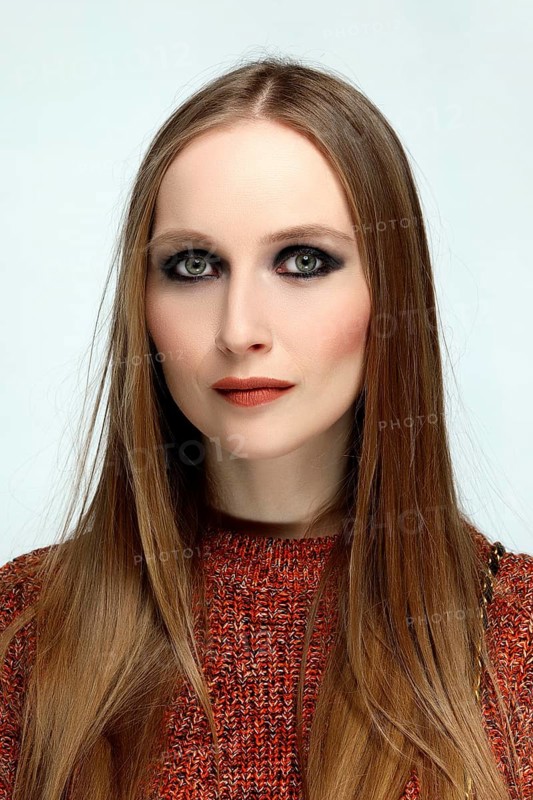 Close up portrait of a girl with provocative evening make up and long hair