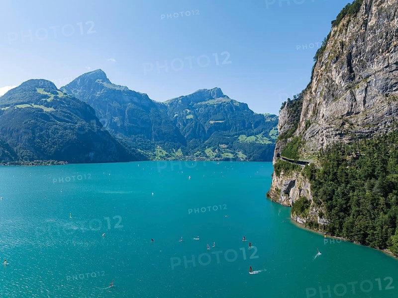 Lake Uri, part of Lake Lucerne near Flüelen, windsurfers in front of the mountains of the Alps. Flüelen, Canton Uri, Switzerland, Europe