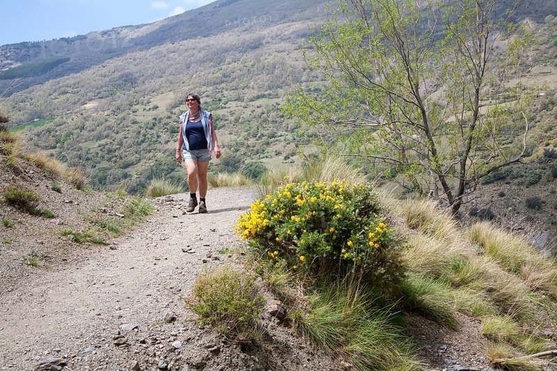 Woman walking in the the River Rio Poqueira gorge valley, High Alpujarras, Sierra Nevada, Granada Province, Spain, Europe