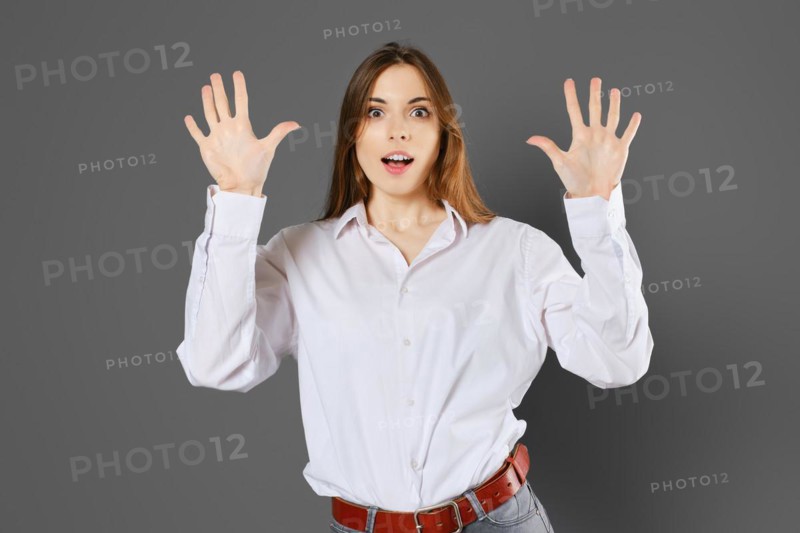 Surprised young woman shows ten fingers. Counting with fingers concept
