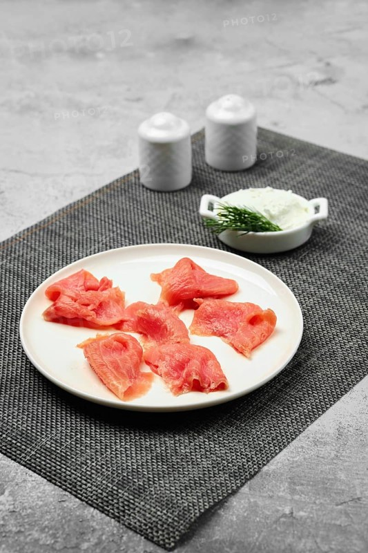 Thin slices of smoked pink salmon on a plate