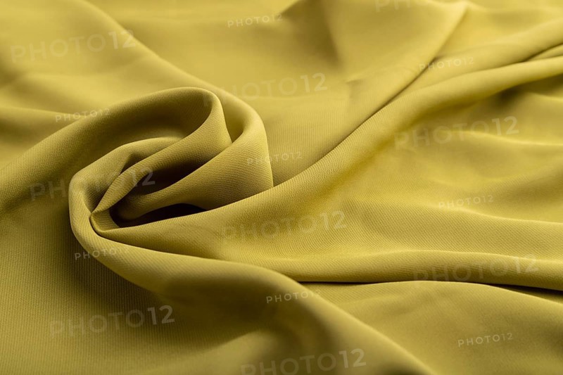 Fragment of green olive silk tissue. Side view, natural textile background and texture. wave concept, abstract, spiral form
