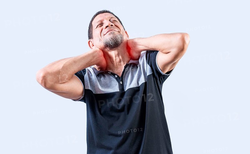 Mature man with neck tension isolated. Neck pain and stress concept. Elderly person suffering with neck pain isolated