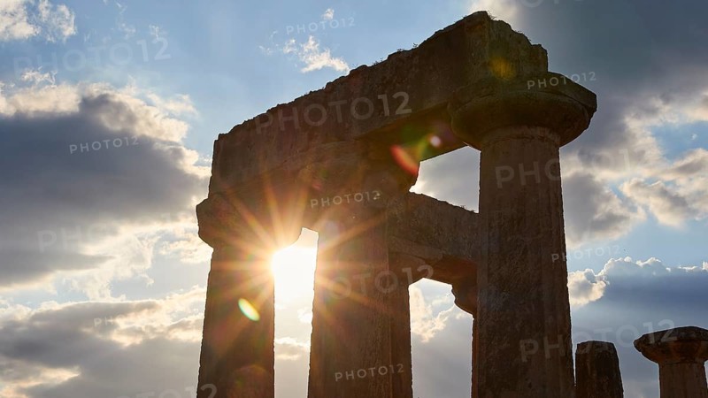 Archaic Temple of Apollo, Doric columns, Sunset behind ancient ruins with shining columns, Archaeological site, Archea Korinthos, Corinth, Peloponnese, Greece, Europe