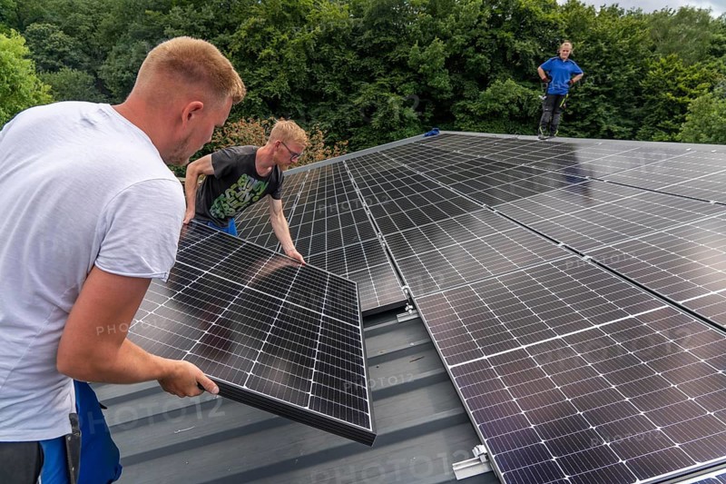 Installation of solar modules on the roof of a barn on a farm, over 210 photovoltaic modules are installed on the roof, North Rhine-Westphalia, Germany, Europe