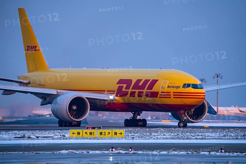 DHL, AeroLogic, Boeing 777F, on the taxiway to Runway West, Frankfurt FRA Airport, Fraport, in winter, Hesse, Germany, Europe
