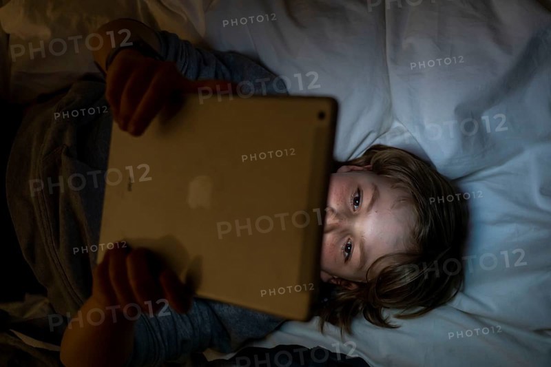 A boy plays computer games on a tablet PC
