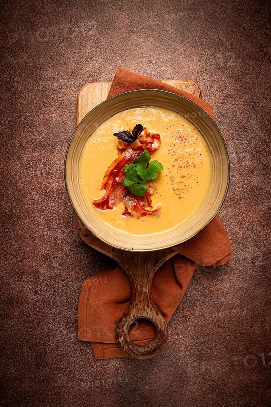 Pumpkin cream soup, curry, fried bacon, top view, no people