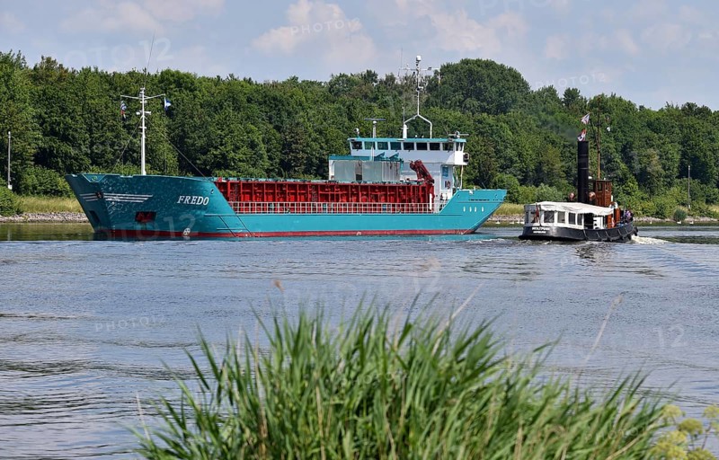 Steam tug Woltman and cargo ship Fredo sailing in the Kiel Canal, Schleswig-Holstein, Germany, Europe