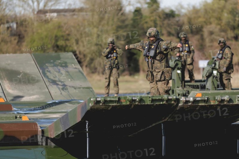 An engineer soldier stands on an amphibious vehicle of the type Amphibie M3 of the Bundeswehr, taken during the military exercise 'Wettiner Schwert' near Tangermünde, 26.03.2024. 'Wettiner Schwert' is part of the Quadriga exercise of the Bundeswehr and the NATO large-scale manoeuvre Steadtfast Defender 2024