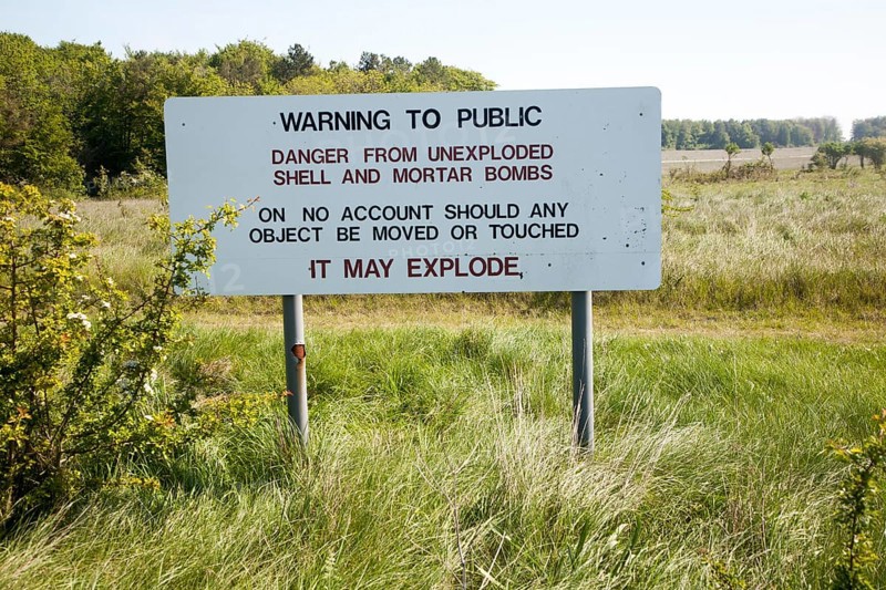 Ministry of Defence warning sign about the danger of unexploded shells and bombs on the firing ranges of Salisbury Plain, Wiltshire, England, United Kingdom, Europe