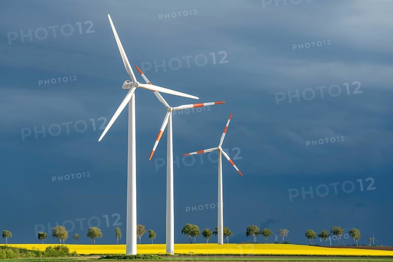 Wind turbines on a rape field, dark rain clouds, in the Rhenish lignite mining area, near Erkelenz-Holzweiler