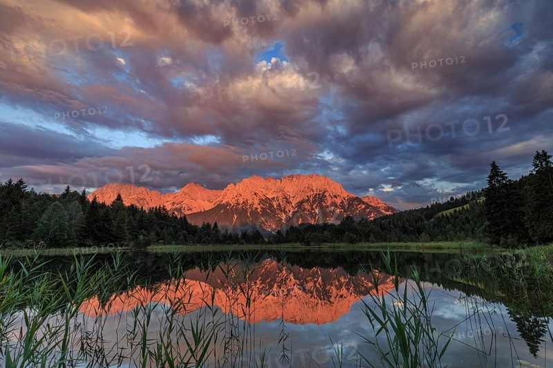 Mountains and clouds reflected in lake, evening light, cloudy mood, summer, Luttensee, Mittenwald, Karwendel Mountains, Bavaria, Germany, Europe