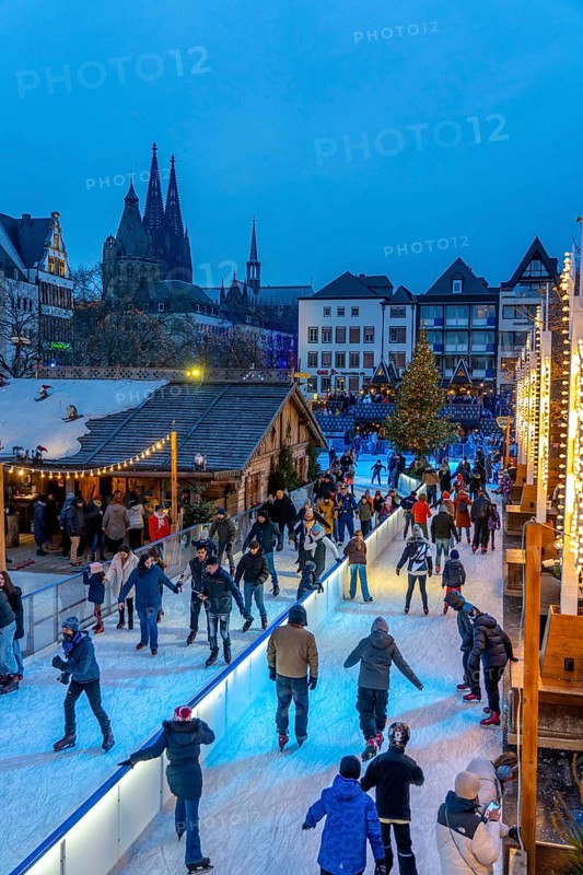 Ice rink at the Christmas market on the Heumarkt in the old town of Cologne, Cologne Cathedral, Sunday shopping in Cologne city centre, 1st Advent weekend, North Rhine-Westphalia, Germany, Europe