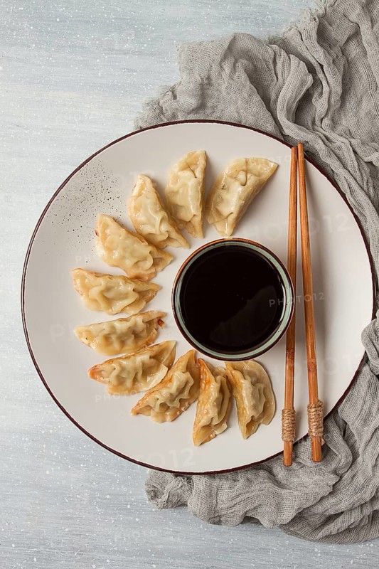 Japanese Gyoza dumplings, fried, with sauce, top view, without people, tinted, selective focus