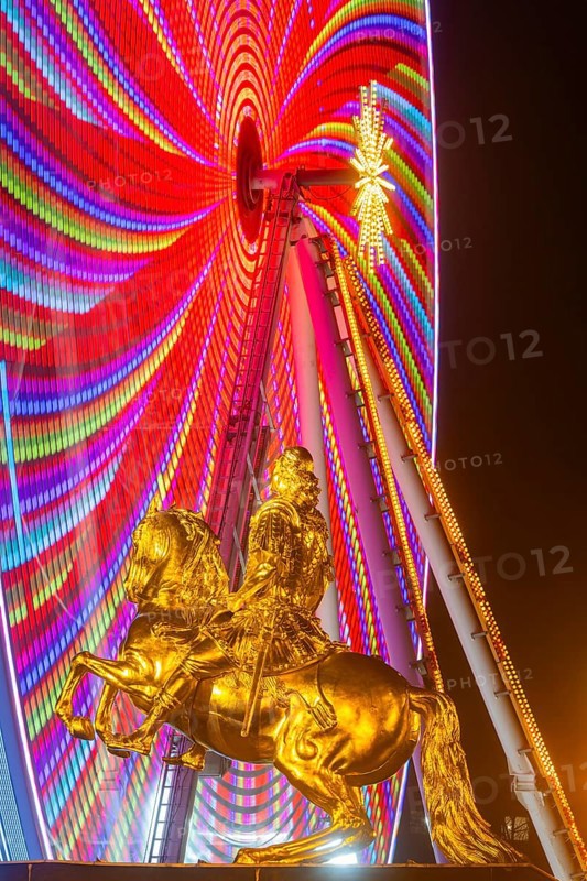 Augustus Market in Dresden. Equestrian statue of Augustus the Strong, also known as the Golden Horseman, with a Ferris wheel turning behind it, Dresden, Saxony, Germany, Europe