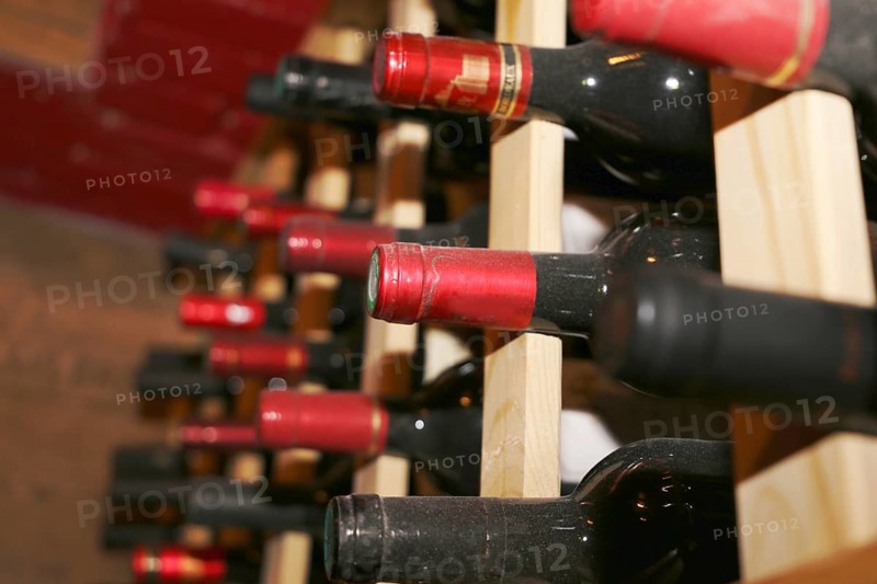 Wine cellar with red wine bottles