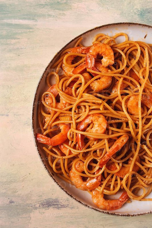 Spaghetti with king shrimps, with spices, top view, selective focus, homemade, no people