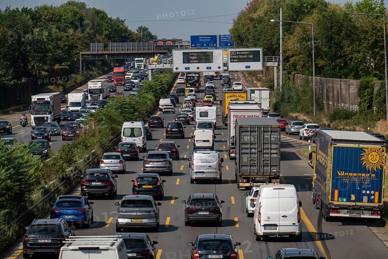 Traffic jam on the A3 motorway, over 8 lanes, in both directions, in front of the Leverkusen motorway junction, Friday afternoon high traffic volume, roadworks, gantry signs with journey times, delays due to the traffic jam, Leverkusen, North Rhine-Westphalia, Germany, Europe