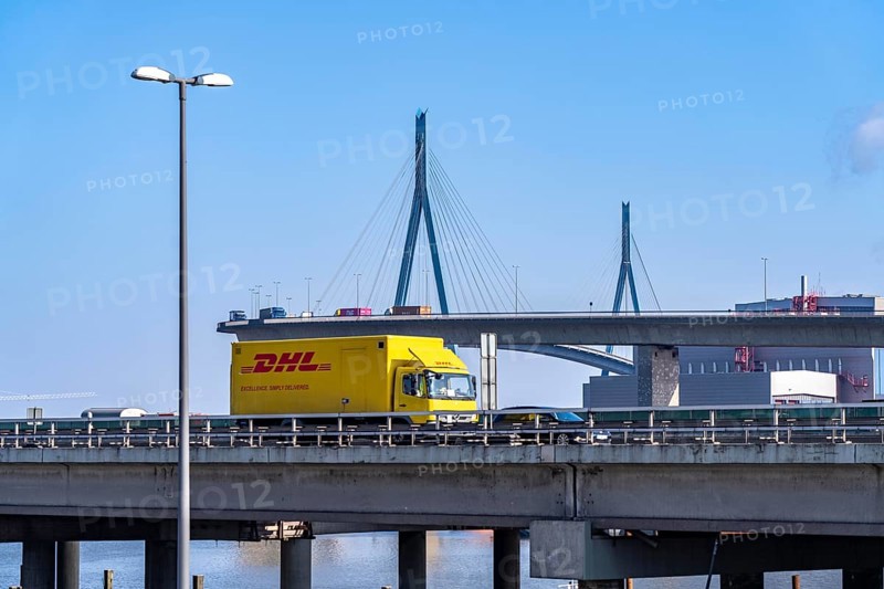The Köhlbrand Bridge in the port of Hamburg, in front traffic on the A7 motorway, spans the 325 m wide Köhlbrand, an arm of the Süderelbe, the bridge is over 3600 metres long, 53 metres above the water, piers 135 m high, more than 30, 000 vehicles use the B3 bridge daily, important connection to the port, it is dilapidated, to be rebuilt, Hamburg, Germany, Europe