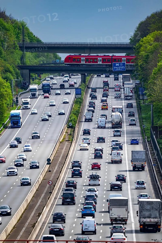 S-Bahn train, crossing the motorway A3, traffic on 8 lanes, incl. the temporarily released hard shoulder, behind the motorway junction Hilden, view in south direction, near Erkrath, North Rhine-Westphalia, Germany, Europe