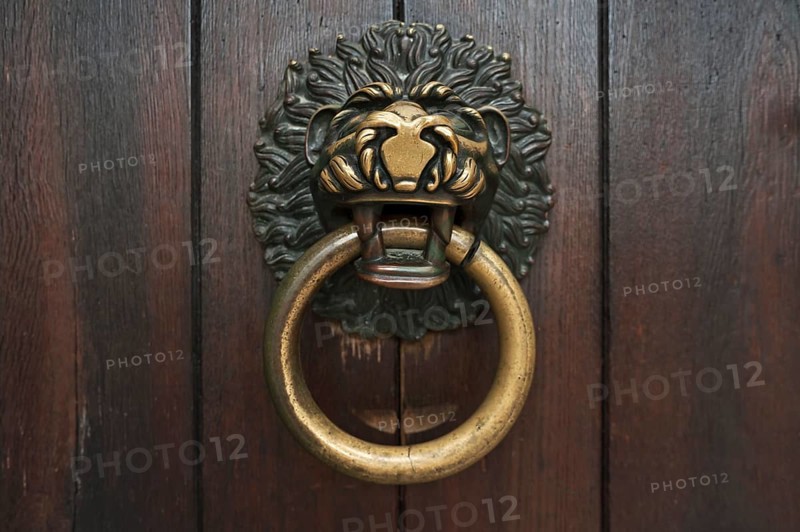Lion's head as a door knocker on the Romanesque entrance portal of the Schottenkirche Sankt Jakob, Regensburg, Upper Palatinate, Bavaria, Germany, Europe