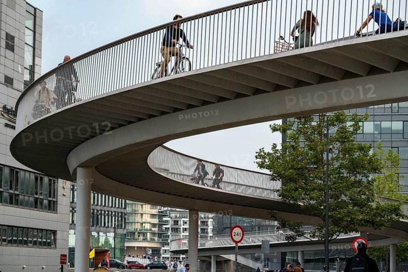 Cyclists on the Cykelslangen cycle and pedestrian bridge, at the Fisketorvet shopping centre, across the harbour, Sydhavnen, Copenhagen is considered the cycling capital of the world, 45 % of the population travel by bike, Denmark, Europe