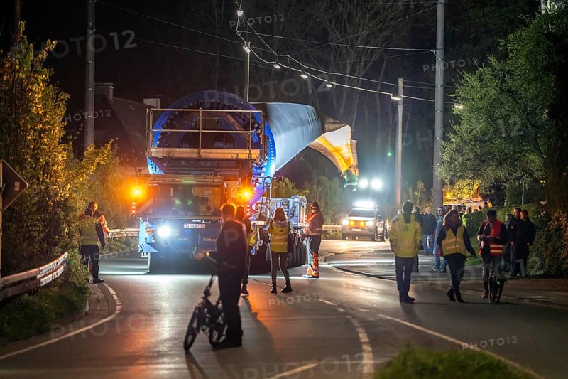 Transport of a 68 metre long, 22 tonne blade of a wind turbine, here in Schwelm, with a self-propelled Blade-Lifter vehicle, over a 40 km long route, over 2 nights, in the Bergisches Land, through towns, villages, over country roads, narrow through roads, to the construction site of the wind turbine near Hagen, North Rhine-Westphalia, Germany, Europe