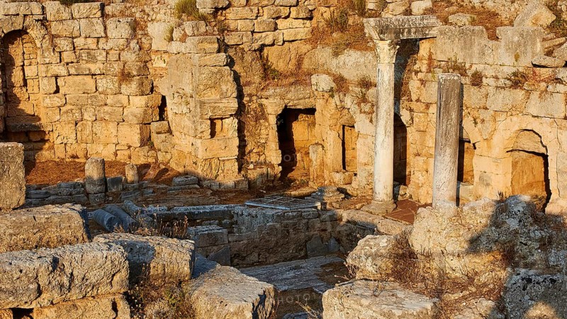The remains of an ancient columned structure under a sunny sky, Peirene Fountain, Archaeological site, Archea Korinthos, Corinth, Peloponnese, Greece, Europe