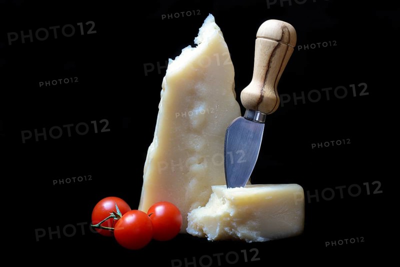 A piece of Parmesan cheese with cheese knife, tomatoes, Italy, Europe