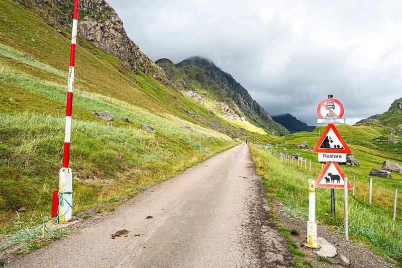 Mountain road from Haukland beach to Uttakleiv, warning signs, no public traffic, be aware of sheep and avalanches, island Vestvågøya, Lofoten, Norway, Europe