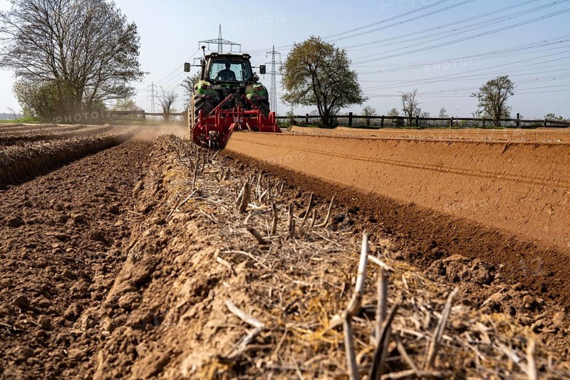 A farmer builds asparagus ridges on a field with the help of an asparagus tiller, in which the asparagus then grows, Dormagen, North Rhine-Westphalia, Germany, Europe