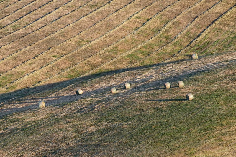 Harvested wheat field with bales of straw, landscape around Pienza, Val d'Orcia, Orcia Valley, UNESCO World Heritage Site, Province of Siena, Tuscany, Italy, Europe