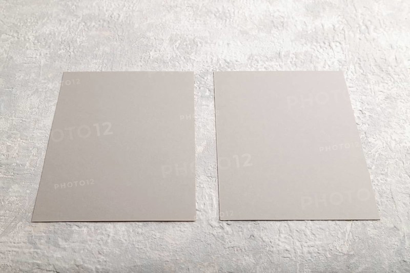 Gray paper business card, mockup on gray concrete background. Blank, flat lay, top view, still life, copy space
