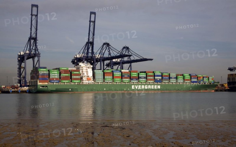 Evergreen container ship and cranes in the Port of Felistowe, Britain's busiest container port, pictured from across the River Orwell at Shotley, Sufolk, England, United Kingdom, Europe