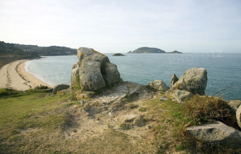 Granite outcrops looking to Bears Beach and island of Jethou, Island of Herm, Channel Islands, Great Britain