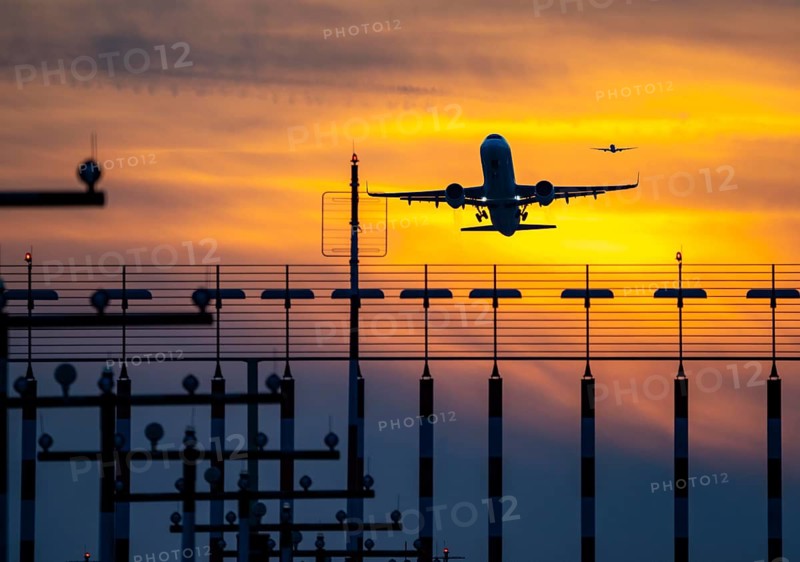 Runway lighting, approach aids, at Düsseldorf International Airport, sunset, aircraft taking off and approaching the southern main runway, 05R/23L, North Rhine-Westphalia, Germany, Europe