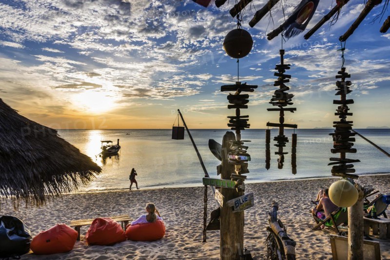 Woman in beanbag in front of a beach bar at Klong Khong beach, beach, beach bar, sea ocean, romantic, calm, time out, holiday time, tourist, holiday, travel, tourism, island, beach holiday, backpacker, hippie beach, evening mood, evening sun, relax, chill out, Caribbean, sun, summer, Asian, travel style, beach holiday, gastronomy, bar, Ko Lanta, Thailand, Asia