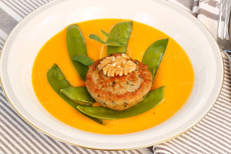 Vegetarian cuisine, walnut cakes on sugar snap peas with pumpkin sauce, sauce, vegetables, snow peas, walnut, savoury, vegan, salty, fried, healthy, main course, soup plate, new cuisine, modern cuisine, beautifully arranged, food photography, studio, Germany, Europe