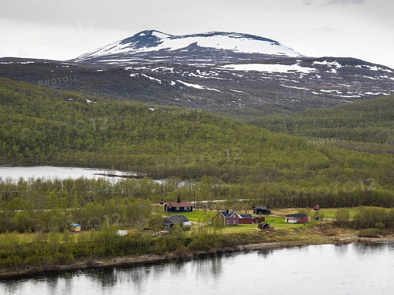 Tana or Tanaelva River, view of small settlement over the river in Norway, which forms the border between Northern Finnish Lapland and Norway, May, Finnmark