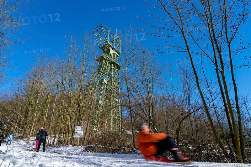Winter in the Ruhr area, toboggan run on a forest path at Lake Baldeney, headframe of the former Carl Funke colliery, Essen, North Rhine-Westphalia, Germany, Europe