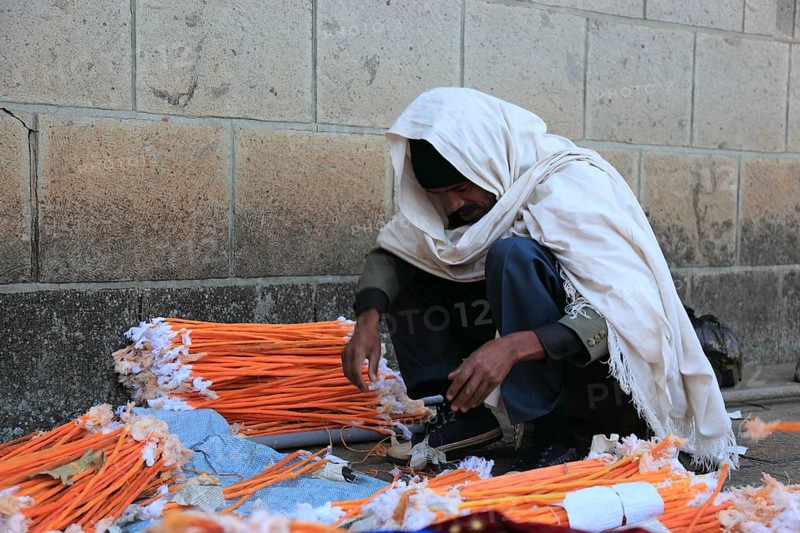 Europia district, Debre Lebanon, Lipanus monastery, man sorting wax torches for the pilgrims at the monastery, Ethiopia, Africa
