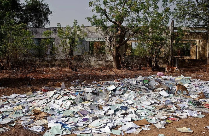 Old schoolbooks thrown away at a rubbish heap Gambia