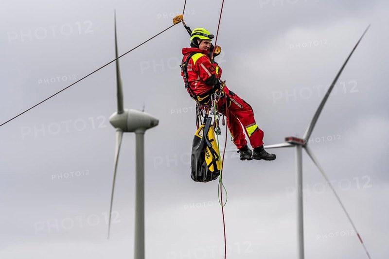 Height rescuers from the Oberhausen fire brigade practise abseiling from a wind turbine from a height of 150 metres after rescuing an accident victim from the nacelle, Issum, North Rhine-Westphalia, Germany, Europe