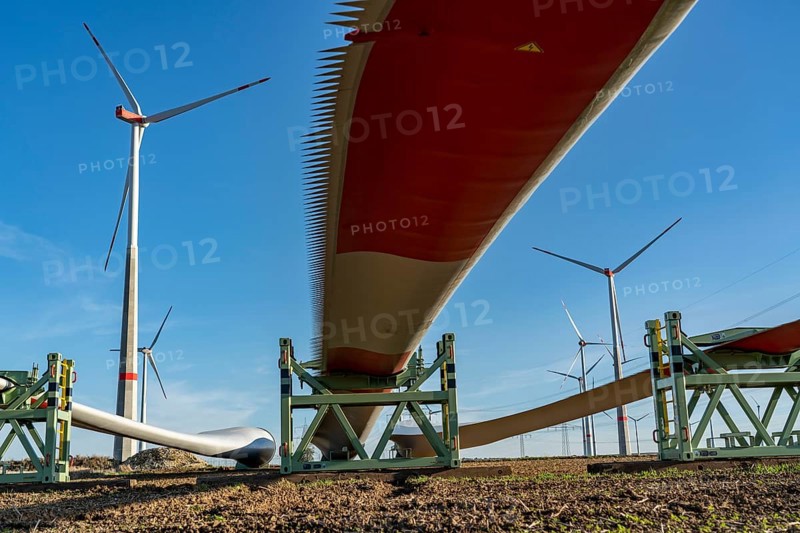 Wind farm near Bad Wünnenberg, construction site, toothing on the rotor blades, so-called Enevoldsen or Dinotails, are intended to reduce the noise of the rotors, storage area for a new wind turbine, components of the mast, the nacelle and the rotors are ready for assembly, North Rhine-Westphalia, Germany, Europe