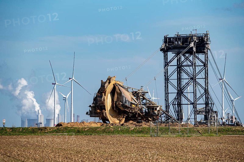 Opencast lignite mine Garzweiler II, bucket wheel excavator dredging, at the edge of the opencast mine near the village of Lützerath, belongs to Erkelenz in the district of Heinsberg, in the background wind farm, and the lignite-fired power plant Neurath, North Rhine-Westphalia, Germany, Europe