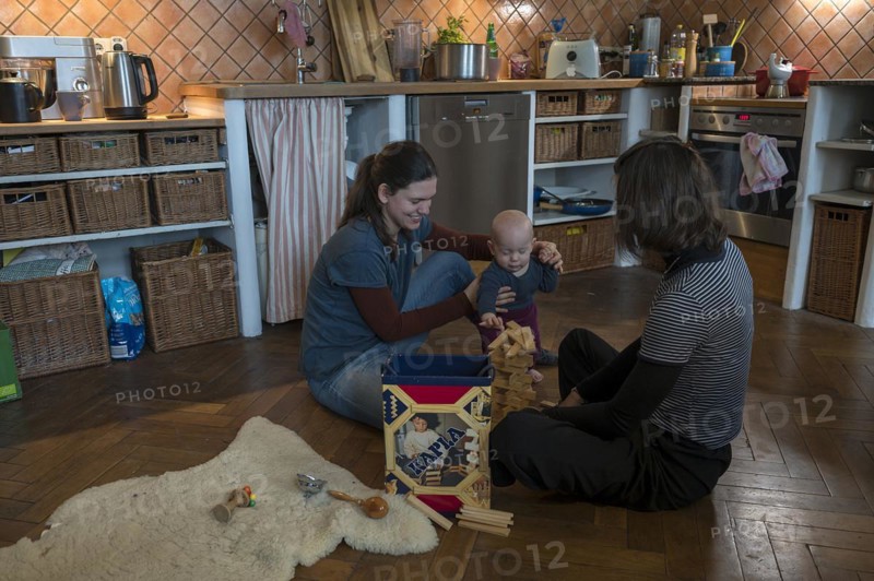 Young mother with her sister and with her son, 8 months, playing on the parquet floor, Mecklenburg-Vorpommern, Germany, Europe
